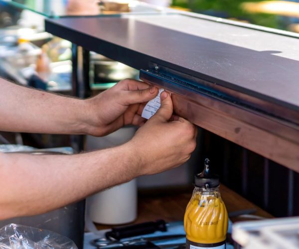 cook-pinning-the-order-paper-above-the-work-place